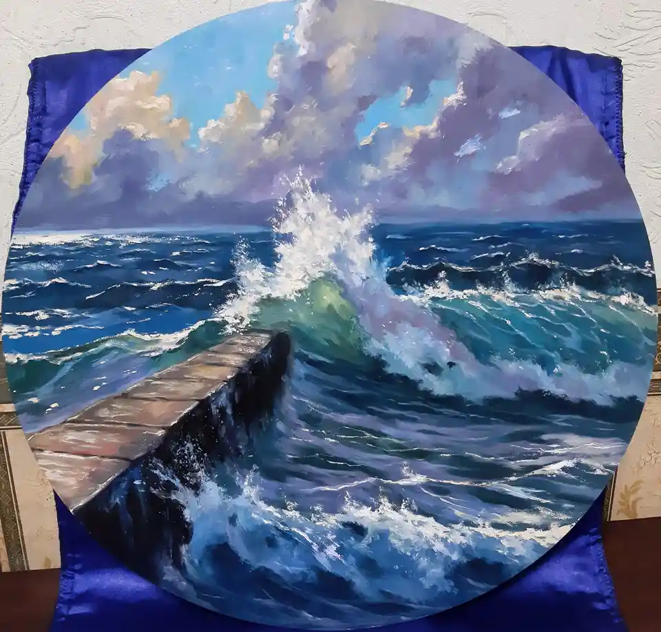 A circular painting depicts a dramatic seascape with turbulent blue-green waves crashing against a stone pier under a cloudy…