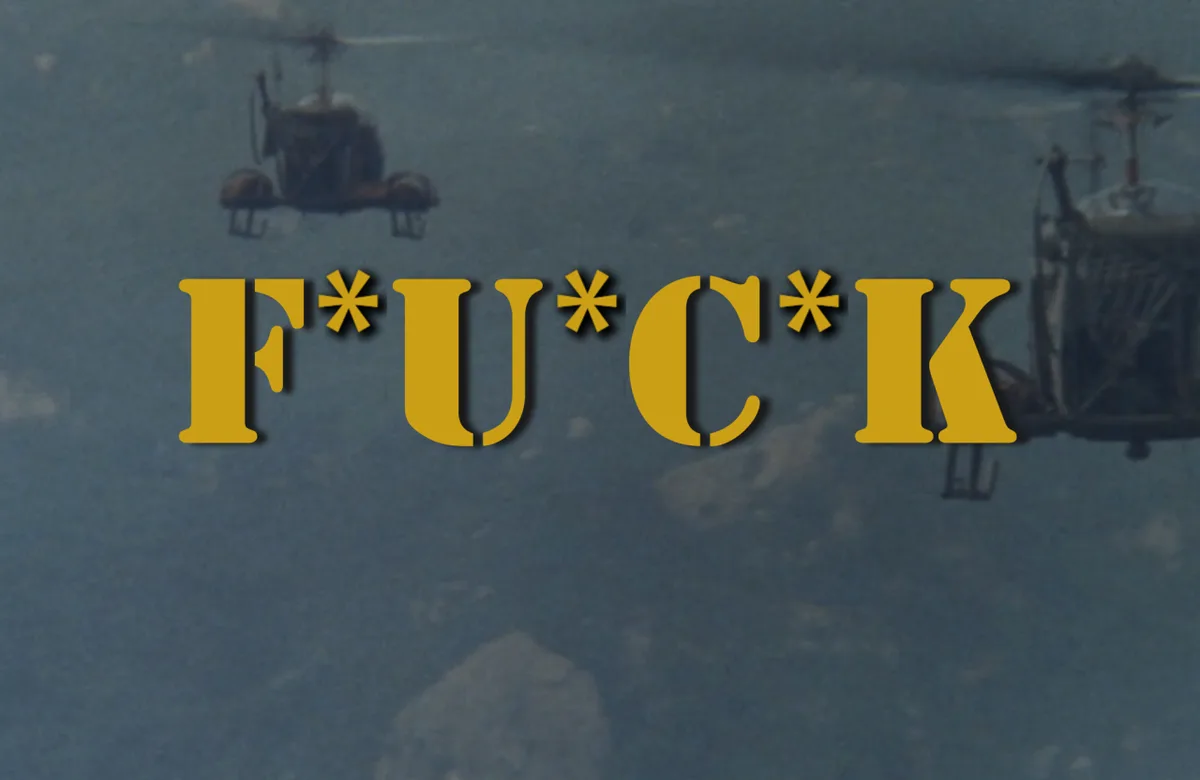 Two helicopters fly in formation over a cloudy sky, with the word 'F*UCK' in large yellow letters overlaid across the center…