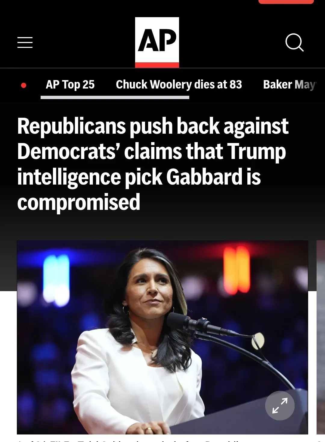 An Associated Press news article screenshot shows a photo of Tulsi Gabbard speaking at a podium with a microphone. The…