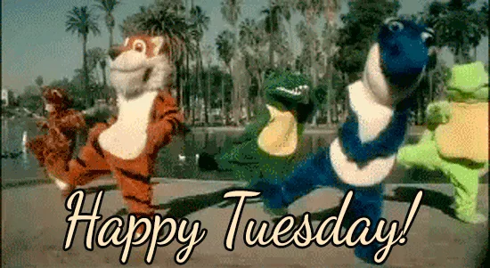 The image displays a repeating sequence of four frames showing four costumed mascots — a tiger, a blue dinosaur, a green…
