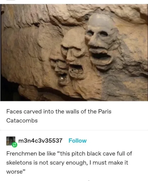 The image shows three grotesque, carved stone faces embedded in a rough, beige rock wall, resembling ancient or macabre…