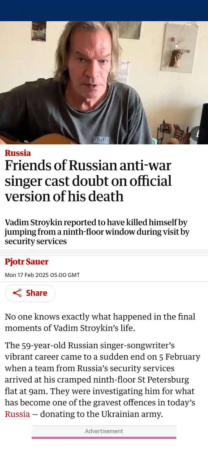 The image shows a screenshot of a news article with a photo of a man with long hair and a grey t-shirt holding a guitar. The…