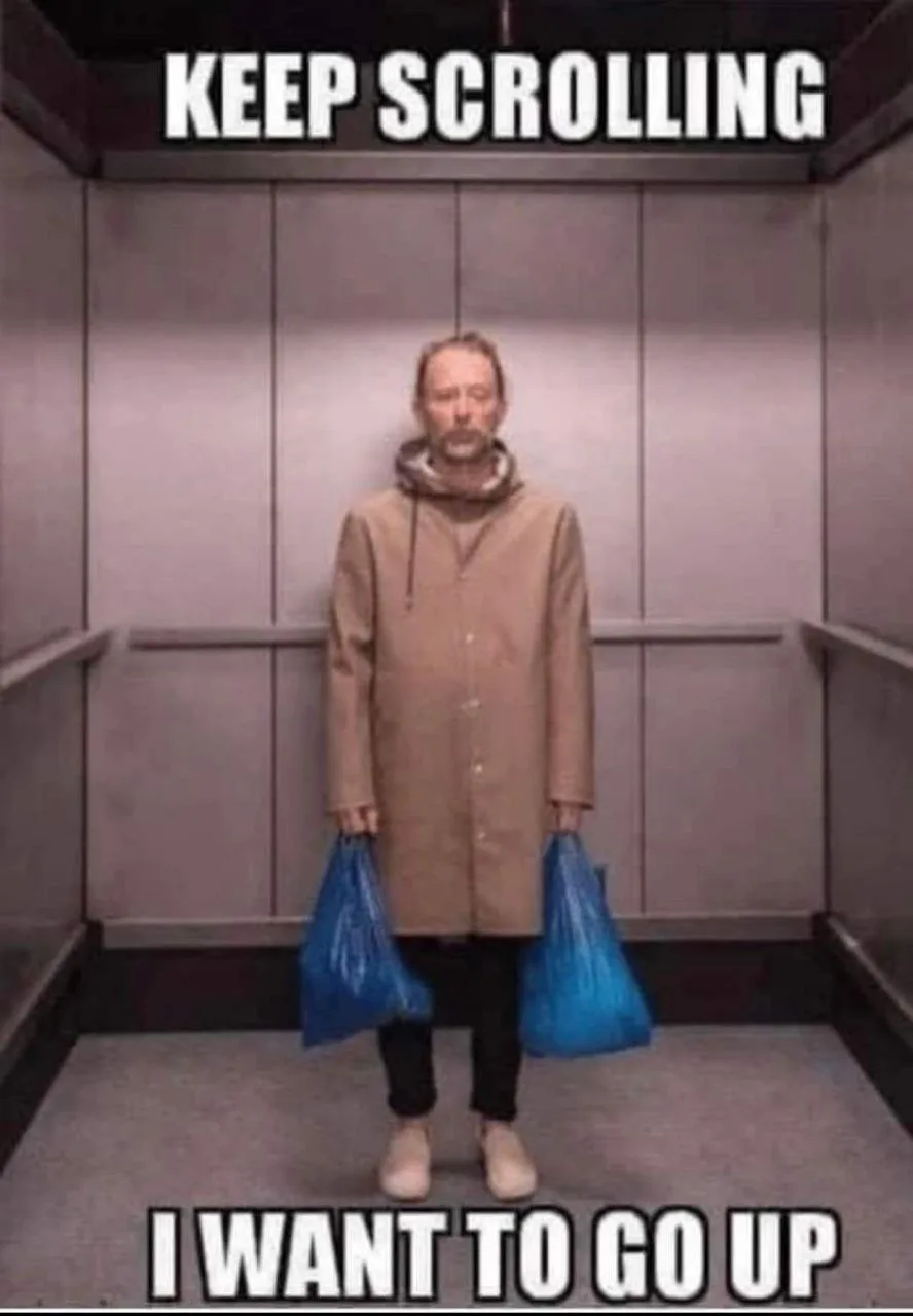 A man in a beige coat stands in an elevator holding two blue plastic bags, looking resigned. The text at the top says 'KEEP…
