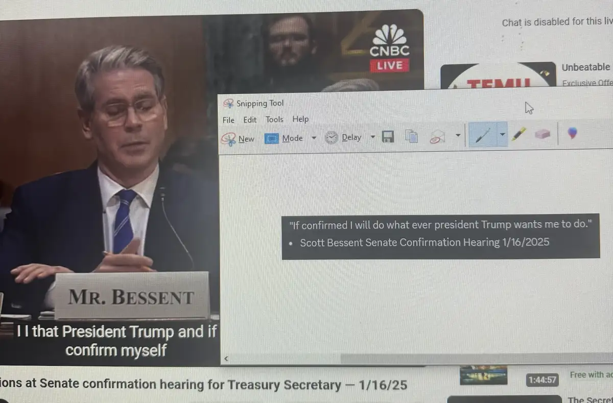 A screenshot of a computer screen shows a CNBC live broadcast of Scott Bessent's Senate confirmation hearing for Treasury…