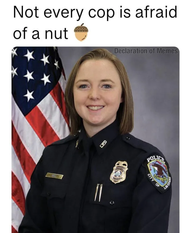 A smiling female police officer in uniform stands in front of an American flag. The text overlaid at the top reads 'Not…
