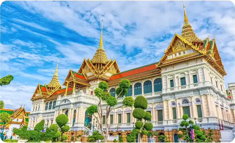 A vibrant, high-resolution photograph of the Grand Palace in Bangkok, Thailand, showcasing its ornate golden spires…