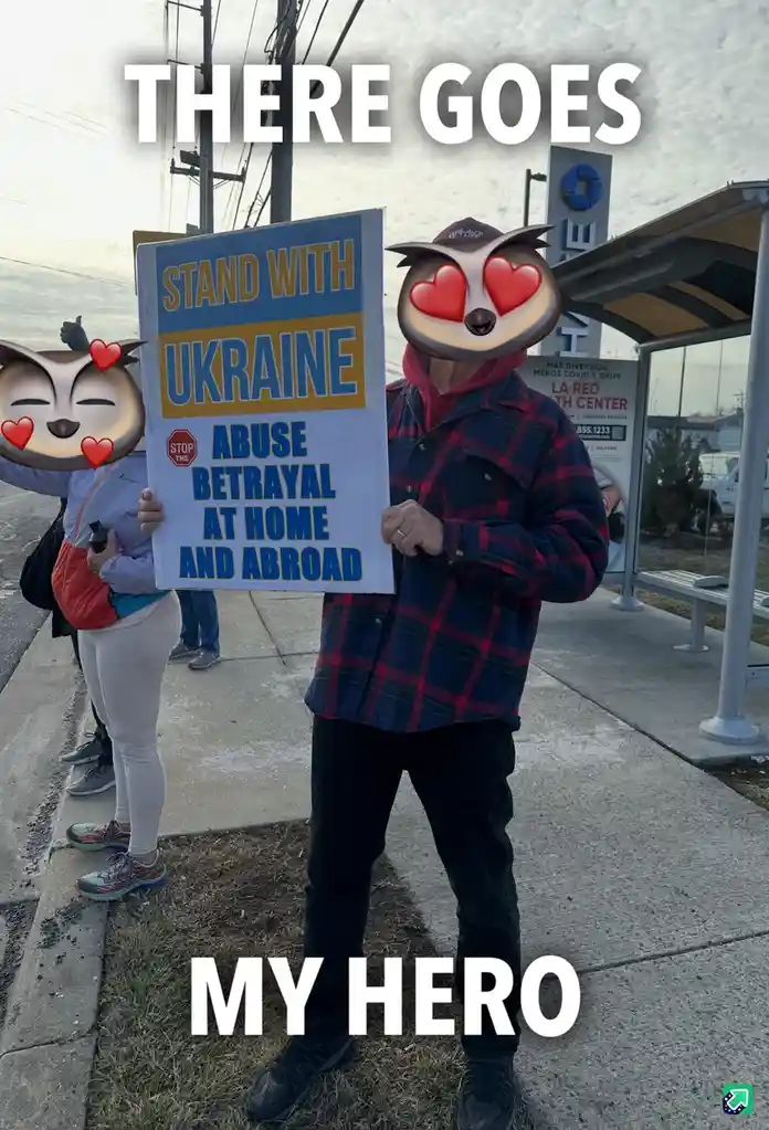 A person wearing a plaid shirt and a heart-eyed owl emoji mask holds a sign that reads 'STAND WITH UKRAINE' and 'ABUSE…