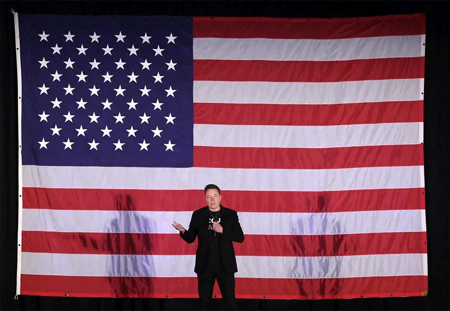 A man in a black suit stands before an American flag that progressively transforms into a thumbs-up icon, then a thumbs-down…