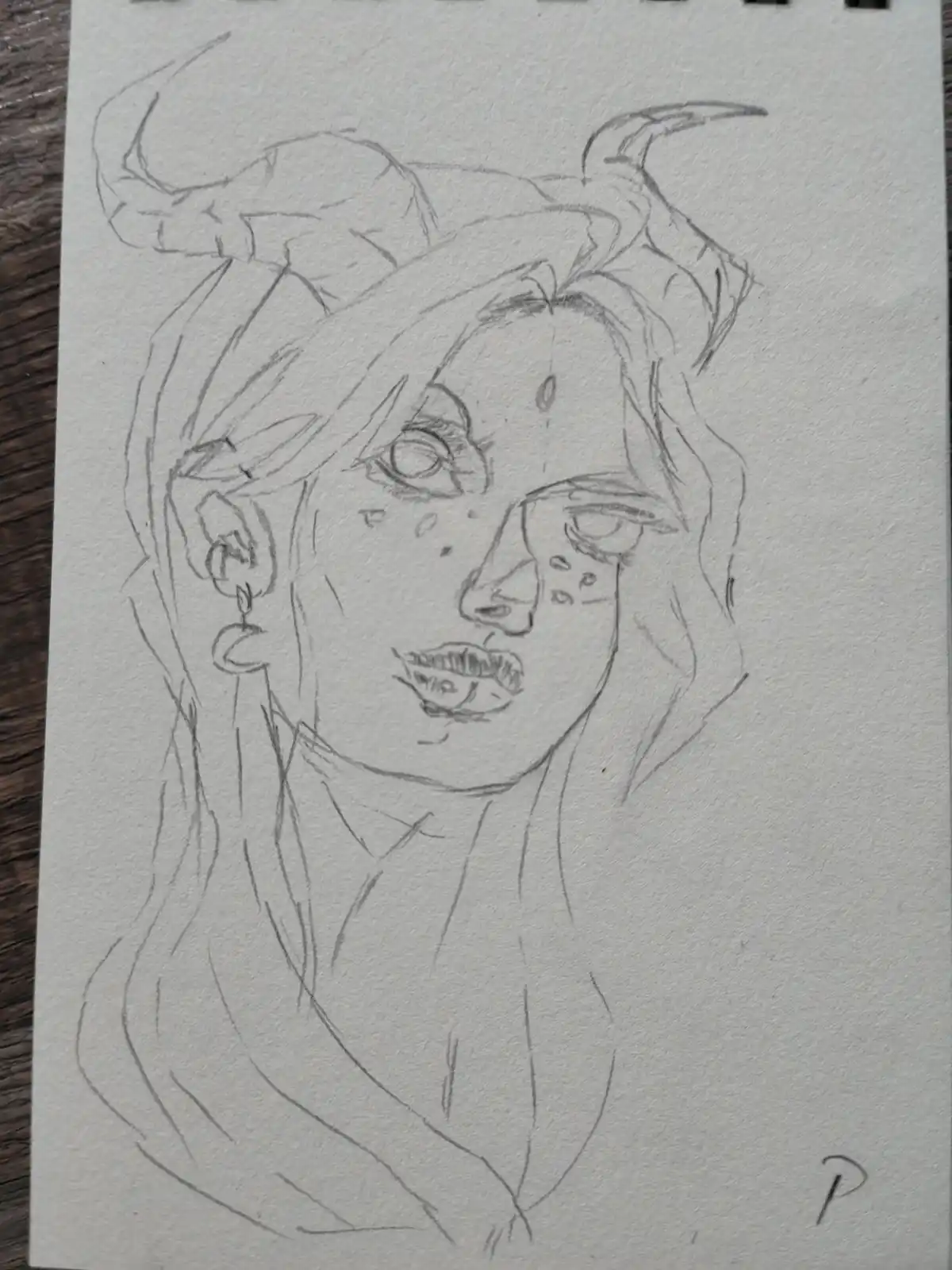 A pencil sketch of a person with horns, tired eyes, and freckles, looking weary. The overlaid text reads 'i'm not a demon…
