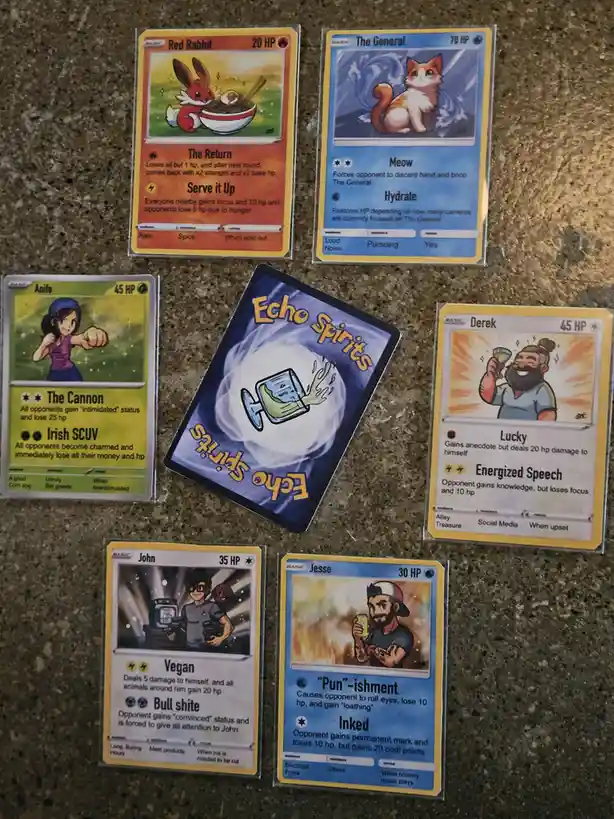 Six custom-designed trading cards resembling Pokémon cards are laid out on a speckled countertop. Each card features a…
