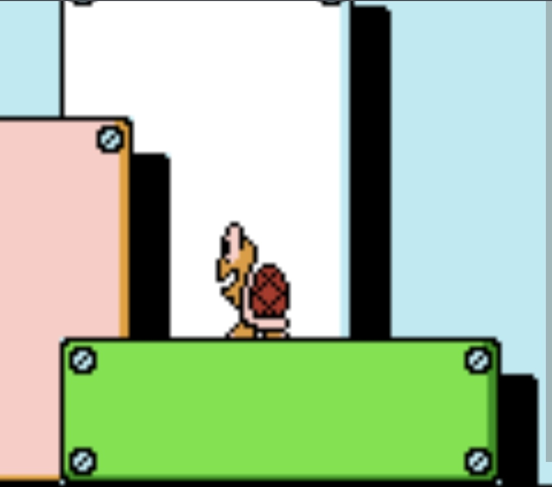 A pixelated Koopa Troopa from a classic Mario game stands on a green platform, looking annoyed or frustrated. The image has…