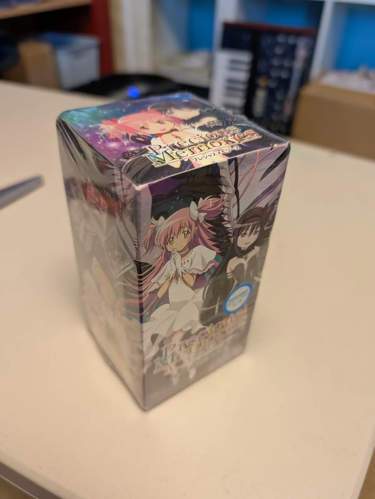 A sealed, rectangular box for the 'Precious Memories' anime trading card game, featuring anime-style illustrations of…