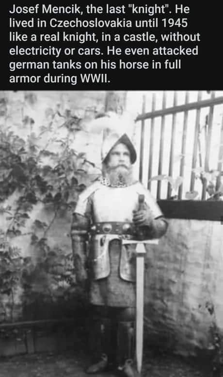 A black-and-white photograph shows a man in full medieval-style armor, including a helmet with a plume, chainmail, and a…