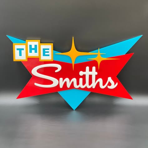 A retro-style, three-dimensional sign with 'THE' in block letters on a yellow background and 'Smiths' in white cursive on a…