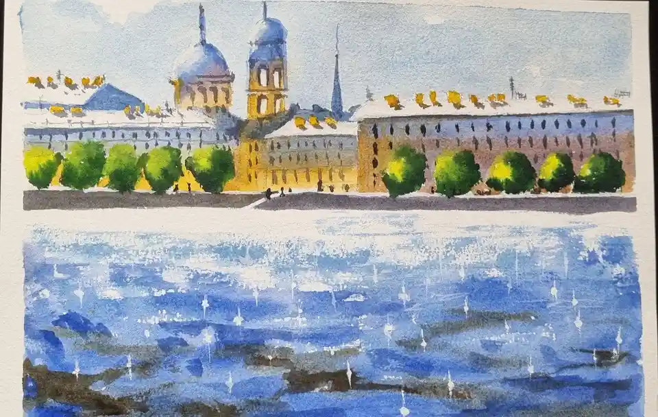 A watercolor painting depicts a snowy cityscape with domed buildings and trees along a riverbank, where the water reflects…