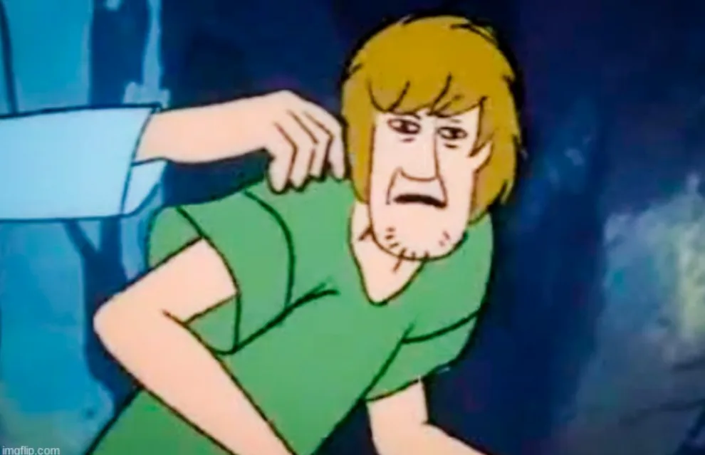 A cartoon character with blonde hair and a green shirt, Shaggy from Scooby-Doo, is shown looking terrified with a hand on…