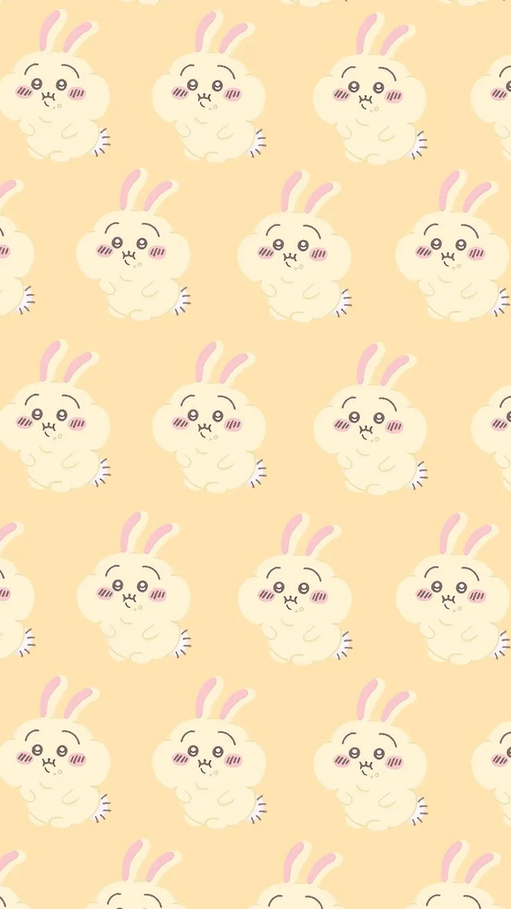 The image displays a repeating pattern of cute, cream-colored cartoon bunnies with pink inner ears, rosy cheeks, and small…