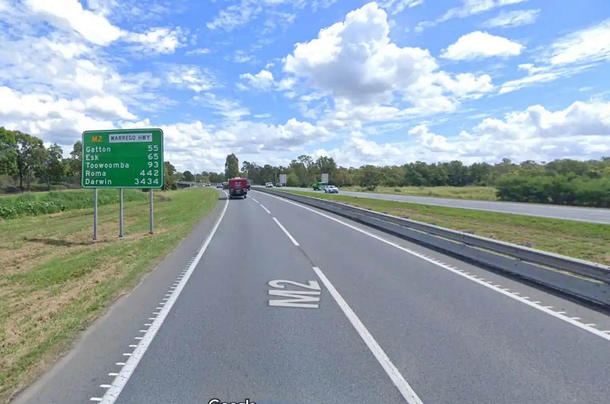 A highway sign on the M2 Warrego Highway in Australia shows distances to various cities, with Darwin listed as 3434 km away…