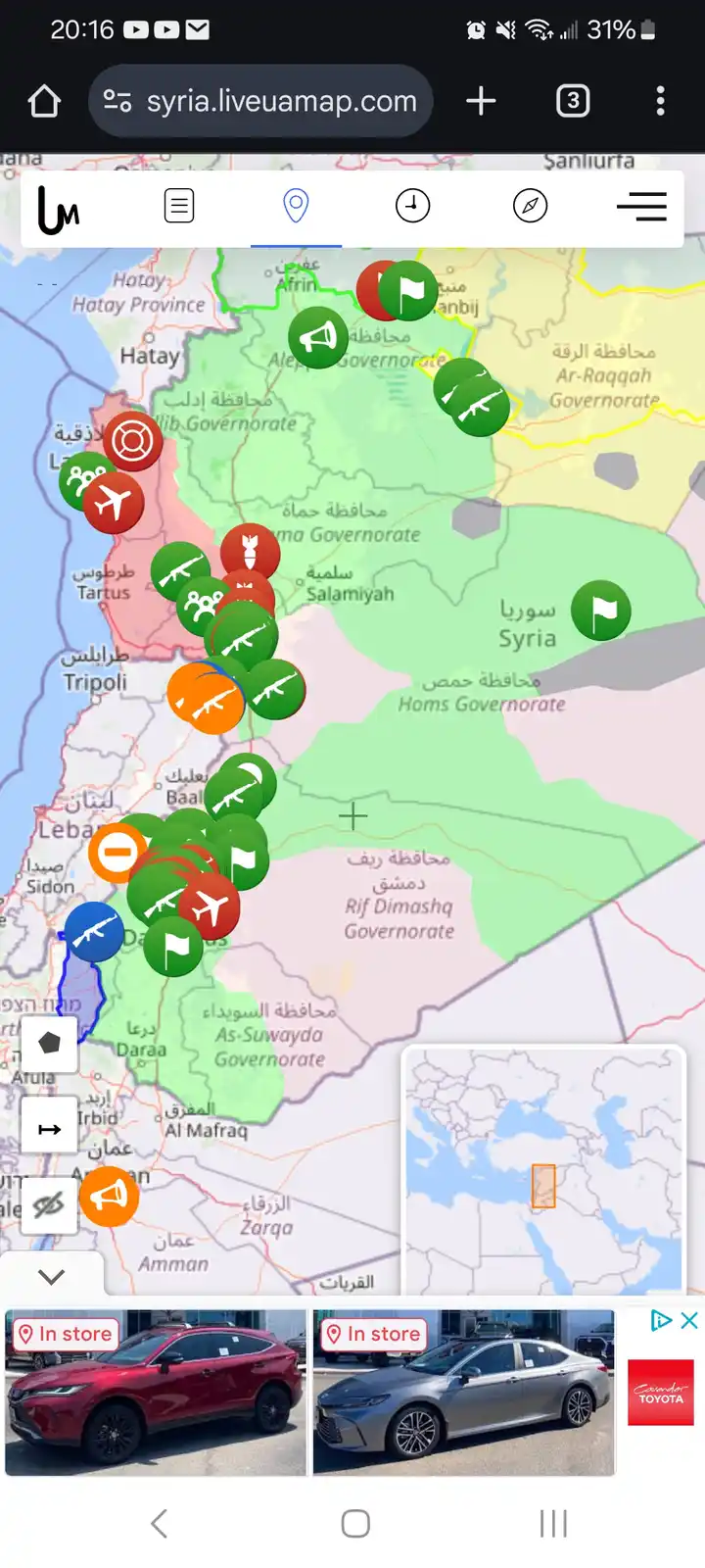 A screenshot of a live map of Syria showing numerous military icons like flags, guns, and planes overlaid on the map, with a…