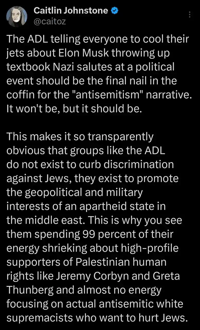 A screenshot of a tweet by Caitlin Johnstone (@caitoz) with a black background and white text. The tweet criticizes the ADL…
