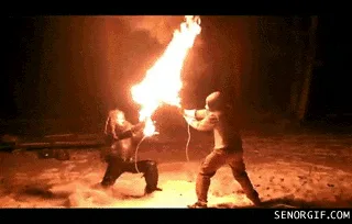 Six sequential frames show two people in a snowy, nighttime setting, struggling to extinguish a large, flaming object they…