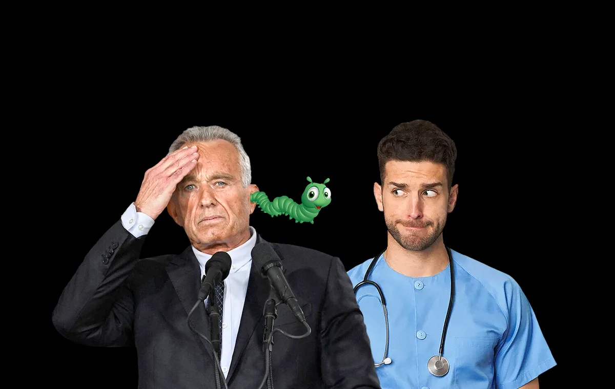 An older man in a suit stands at a podium with microphones, hand on his forehead in confusion or distress, while a cartoon…