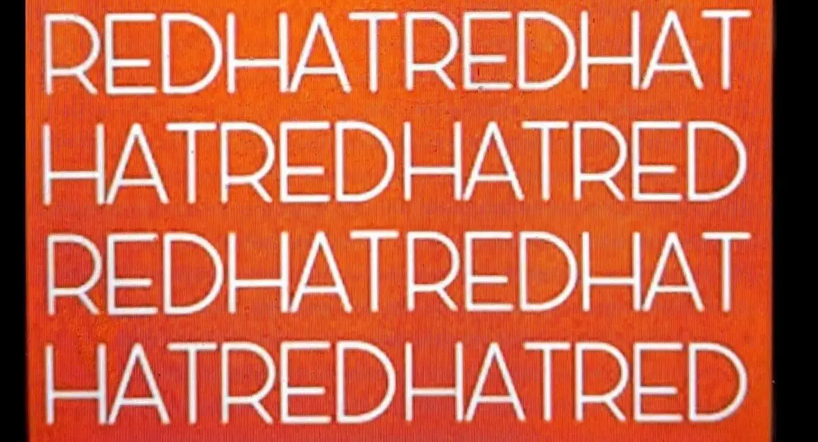 The image displays a solid orange background with four lines of bold white text that alternate between 'redhatredhat' and…