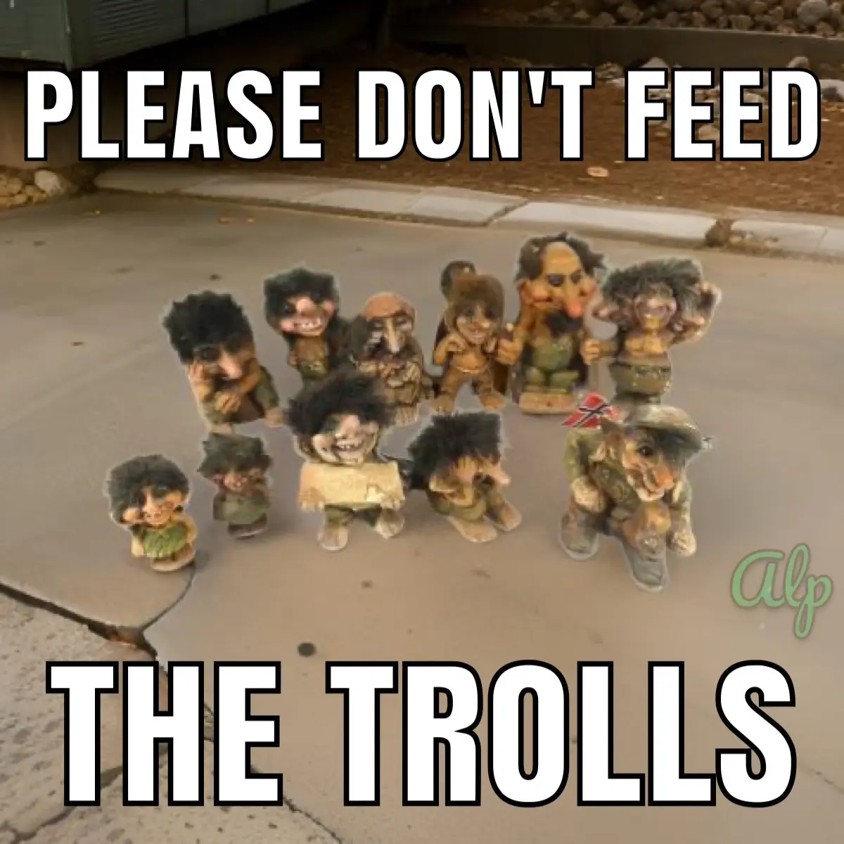A group of small, grotesque troll figurines are arranged on a sidewalk, with large white text overlaid at the top reading…