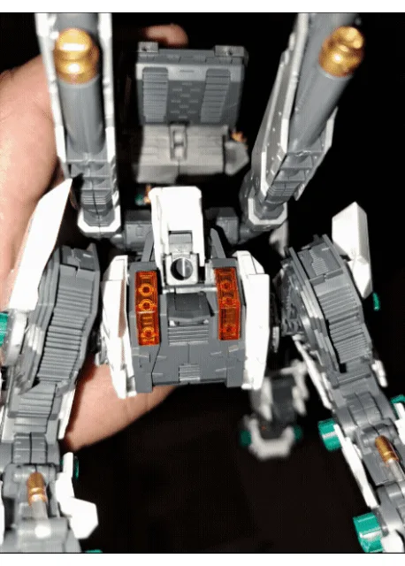 six panels show a gray and white robot toy being held in a hand, with red lights glowing in its chest area across different…