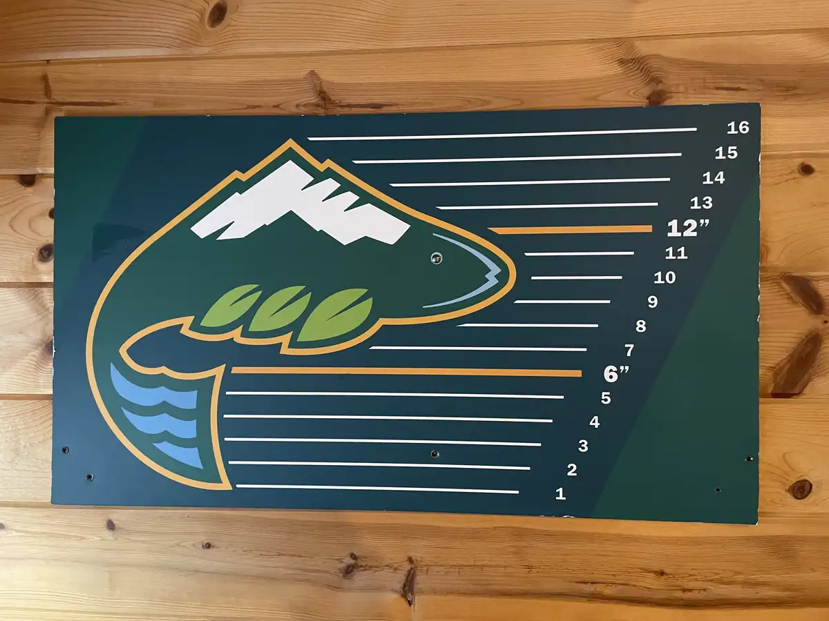 A growth chart shaped like a fish, featuring a stylized fish logo with mountains on its head and leaves in its mouth…