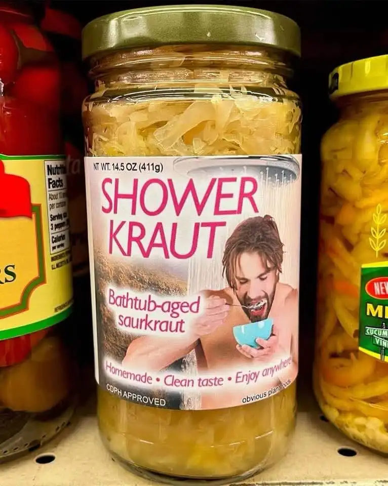 A jar of sauerkraut on a grocery store shelf has a parody label that reads 'SHOWER KRAUT' with an image of a man eating from…