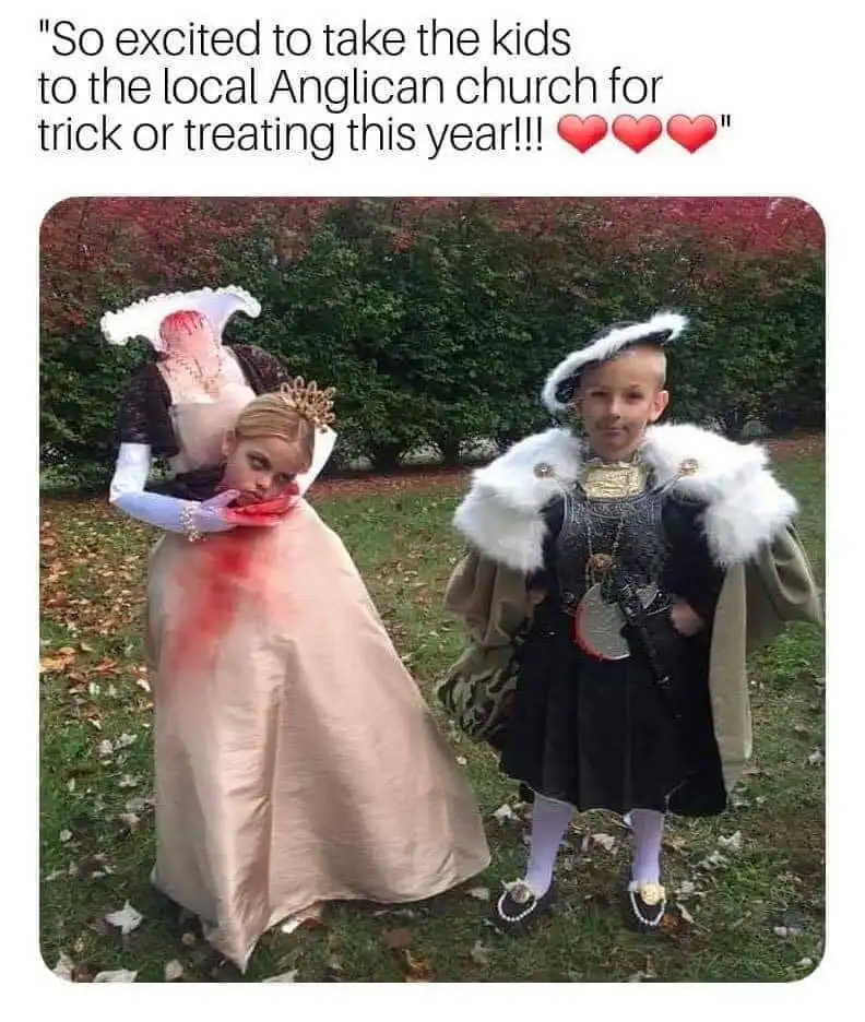 Two children dressed in elaborate, gory costumes resembling historical figures, one as a bloodied queen and the other as a…