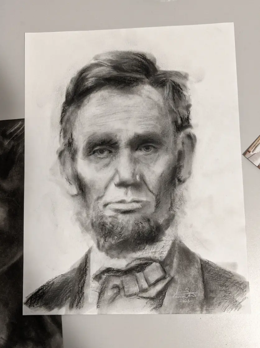 A realistic charcoal sketch of Abraham Lincoln's face and upper torso, showing his beard, bow tie, and stern expression. The…