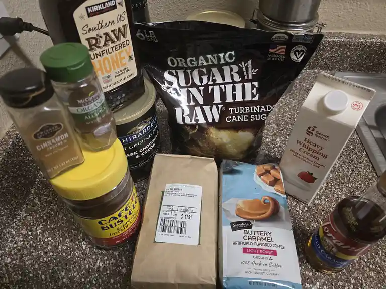 A kitchen counter displays an assortment of sweet ingredients including a large bag of 'Organic Sugar in the Raw' turbinado…