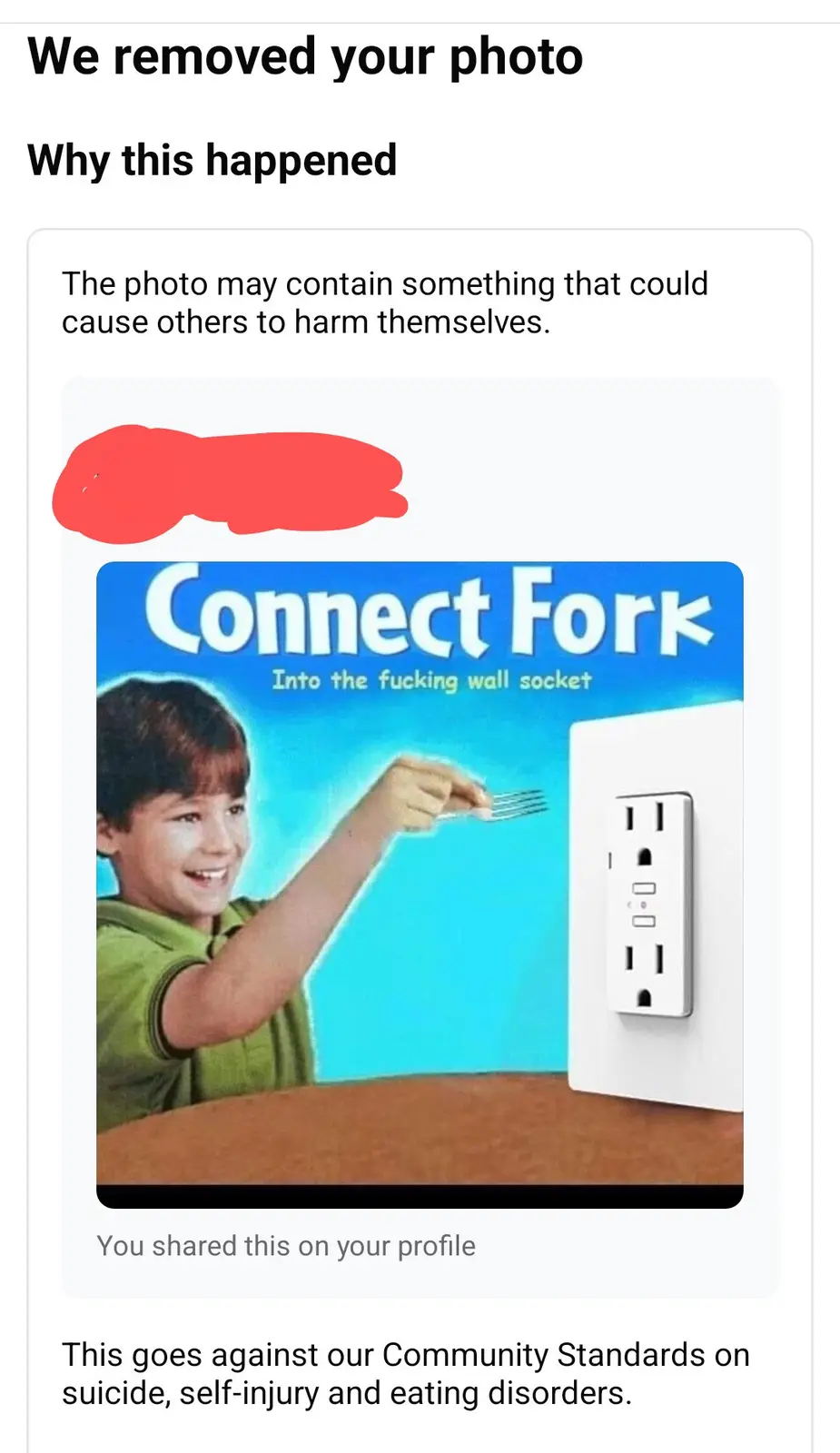 An image mimicking a social media content removal notice, showing a blurred photo above a meme image of a smiling child…