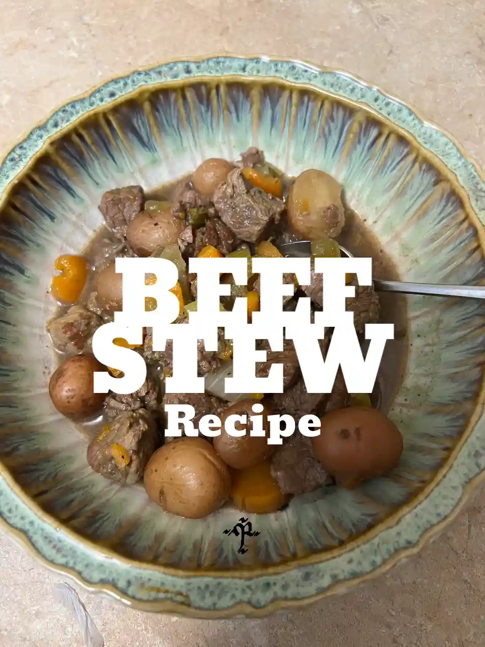 A bowl of beef stew with chunks of meat, potatoes, and carrots in a ceramic bowl with a blue and brown patterned rim. The…