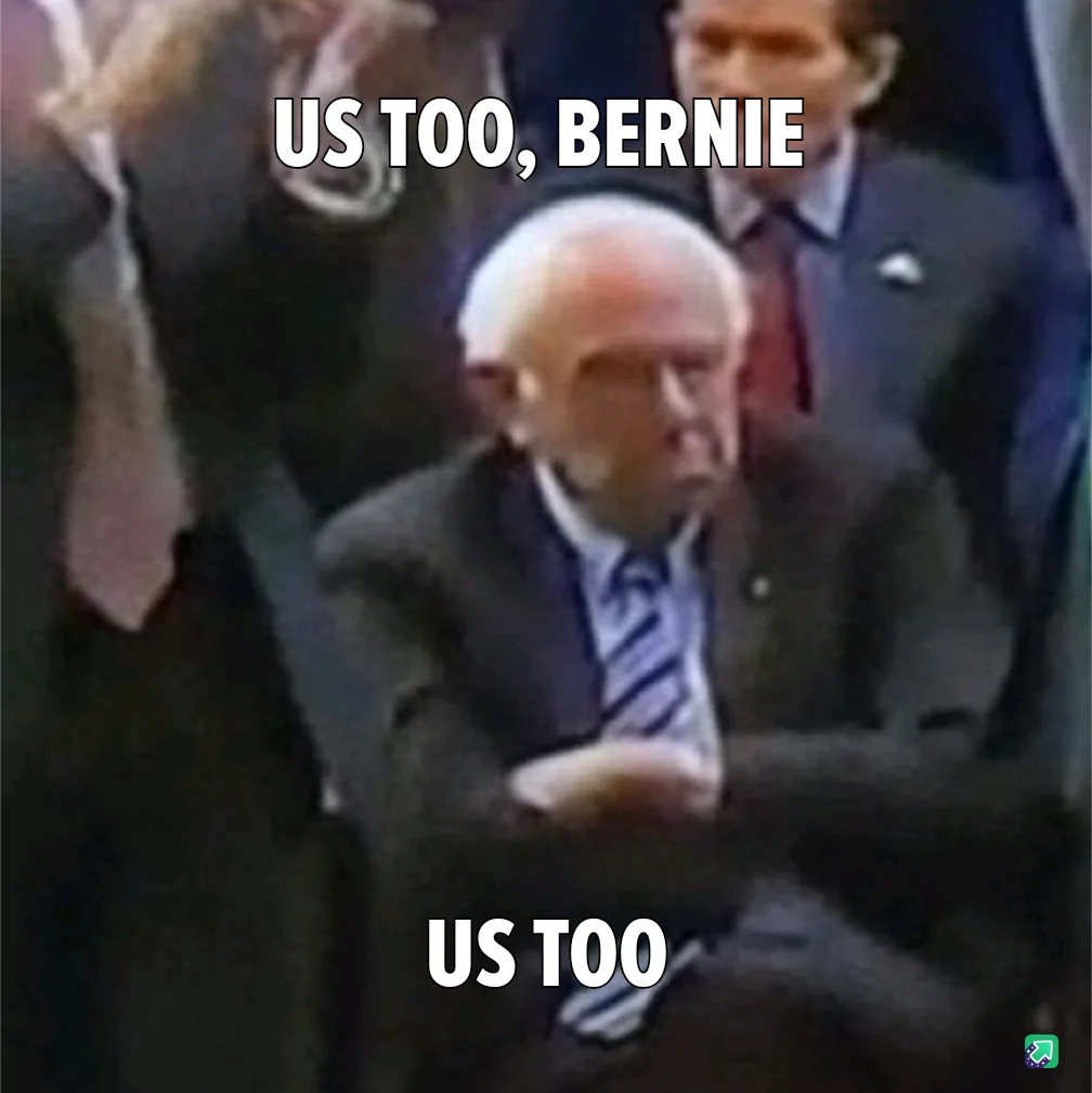 A blurry image shows Bernie Sanders seated, looking down with a serious expression, while text overlaid at the top reads 'US…