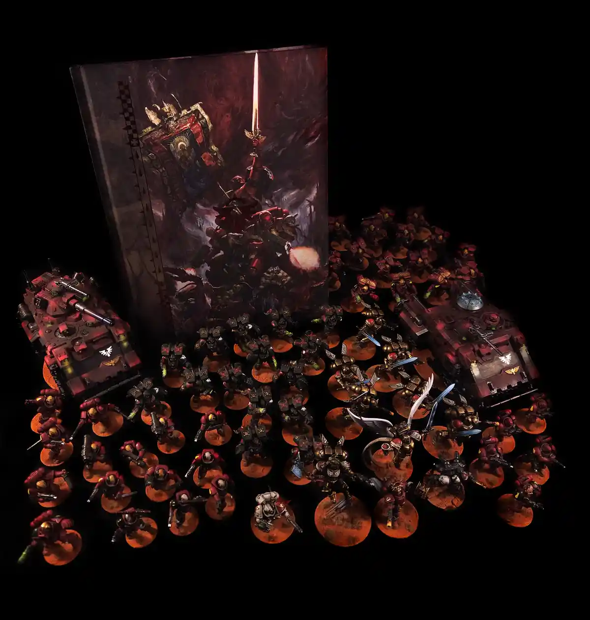 A large collection of painted Warhammer 40,000 miniatures, including infantry, tanks, and a prominent winged figure, are…