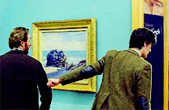 A sequence of six images shows a man in a suit walking through an art gallery, initially pointing at a Van Gogh painting…