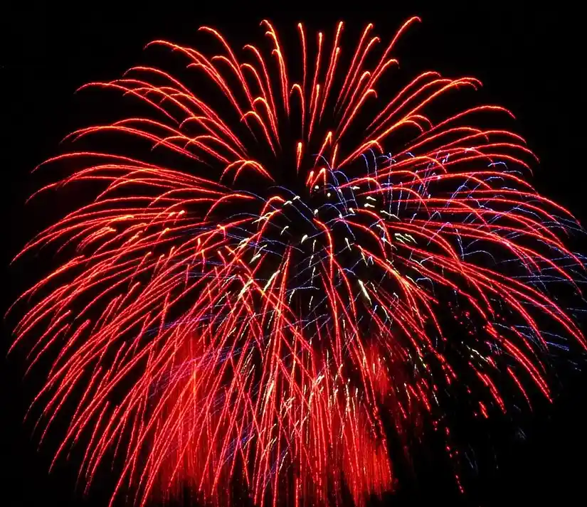 A vibrant fireworks explosion with red and blue streaks against a black sky, overlaid with the text 'i'm not crying, you're…