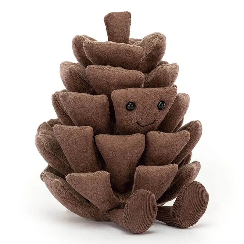 A brown plush pinecone toy with a smiling face and small black eyes sits upright against a white background. It has two…
