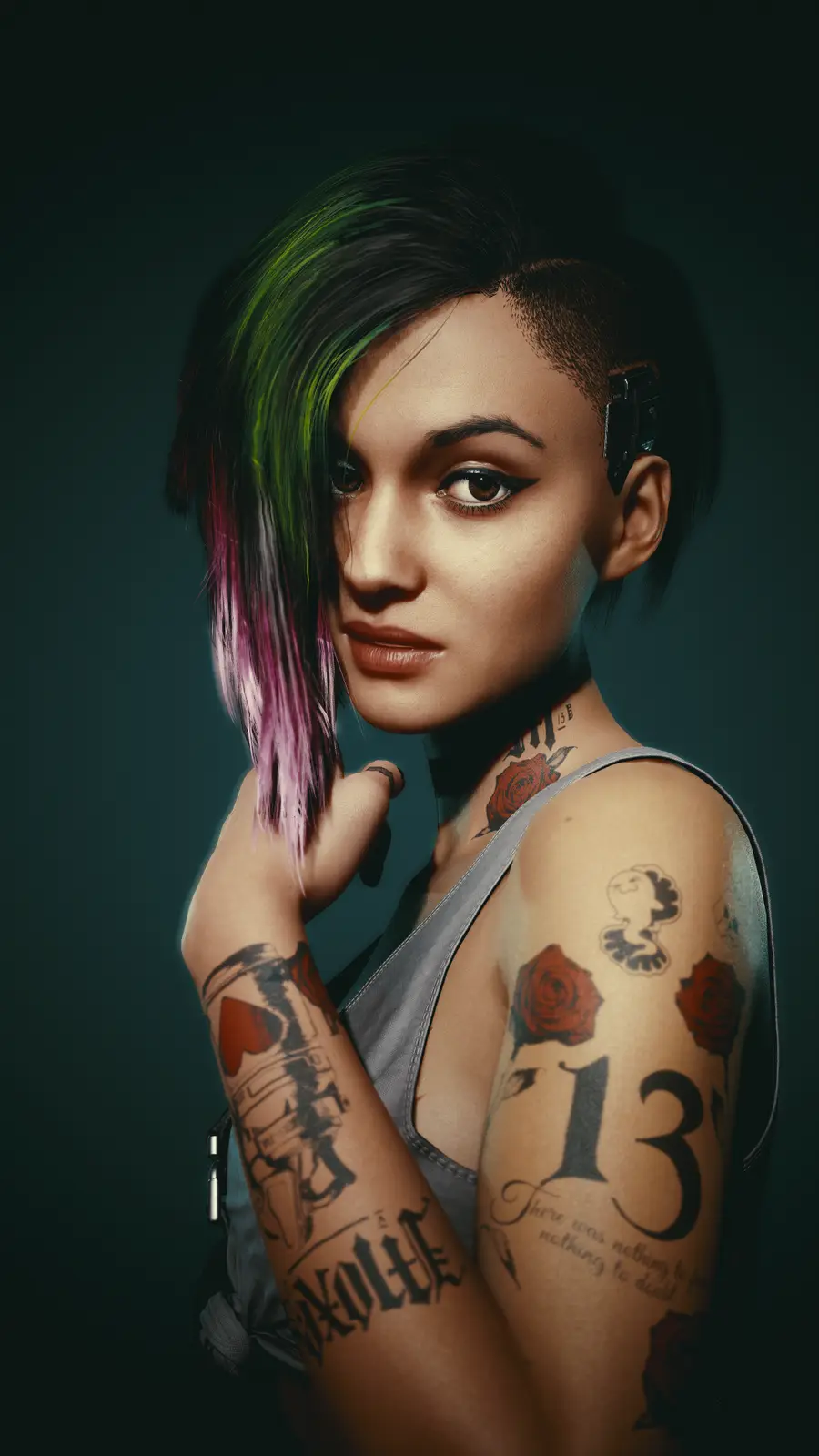 A woman with short, multi-colored hair (green, pink, black) and numerous tattoos on her arms and neck, including roses, the…