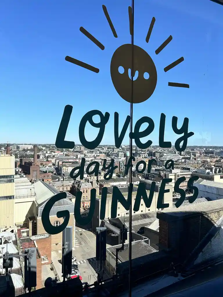 A bright, sunny day is visible through a window overlooking a cityscape, with a simple cartoon sun sticker and the text…