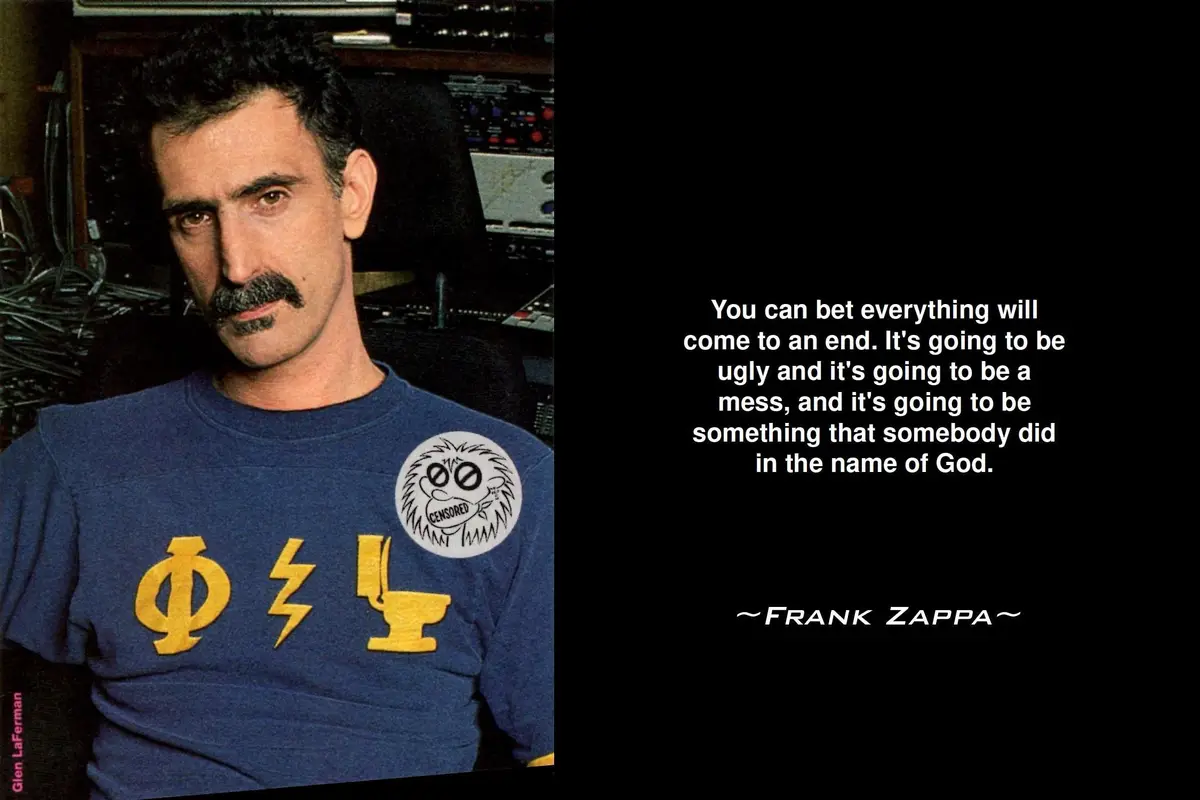 A photograph of Frank Zappa wearing a blue t-shirt with yellow symbols and a 'CENSORED' patch, seated in front of audio…