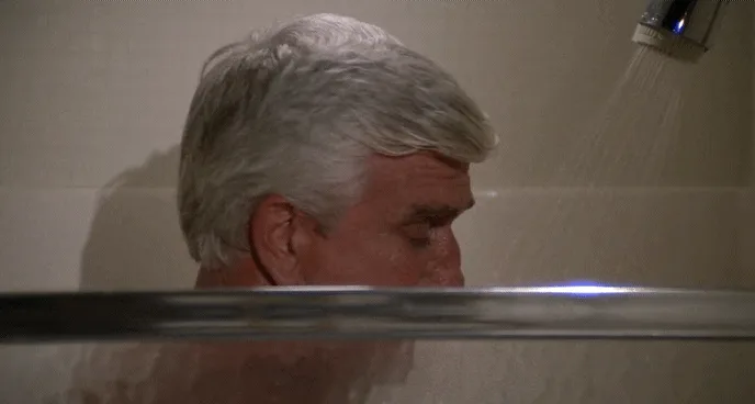 A six-panel image sequence shows a man with gray hair in a shower, progressively turning his head to look directly at the…