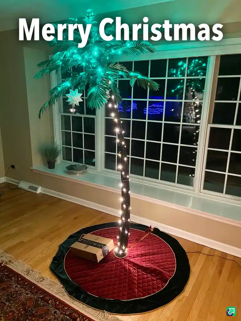 A palm tree decorated with string lights and a star ornament stands in a living room, placed on a red and black quilted tree…