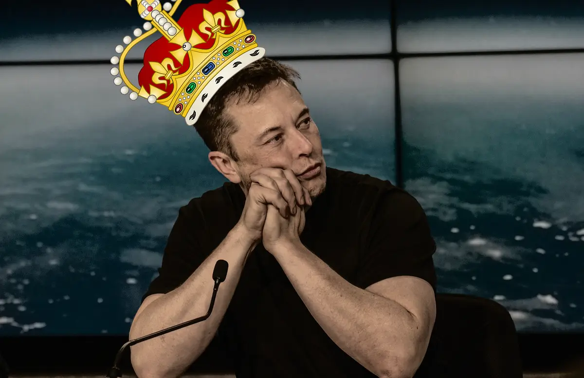 elon musk is shown sitting with his hands clasped under his chin, wearing a large, ornate, digitally added golden crown with…