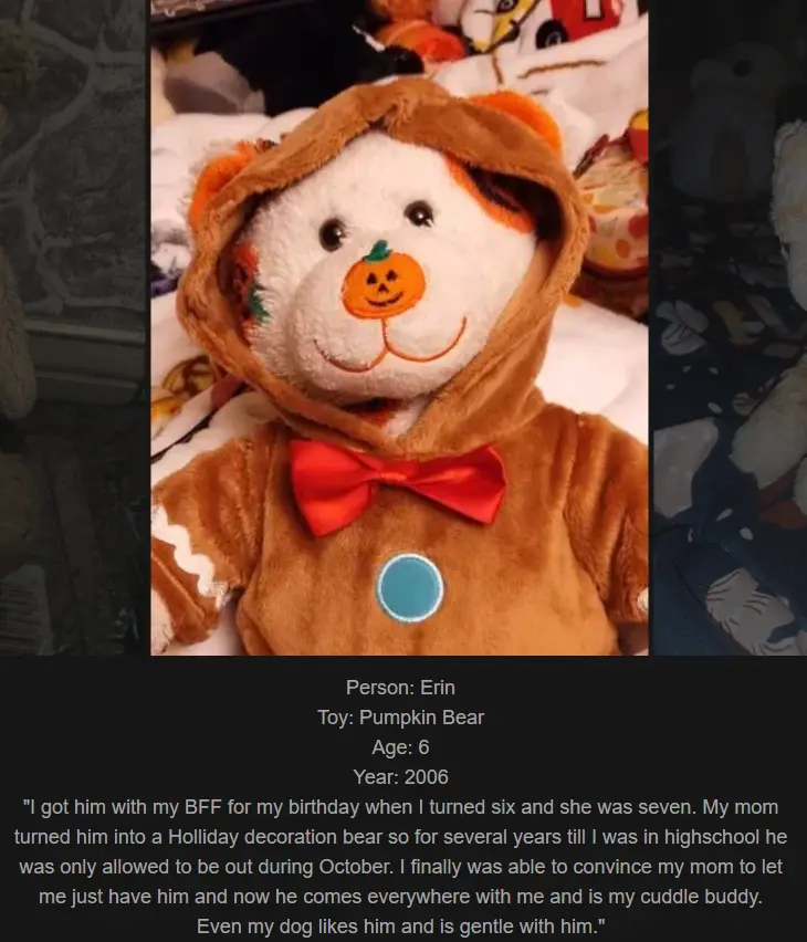 A plush teddy bear wearing a brown Halloween costume with a pumpkin face on its chest and a red bowtie, sitting on a bed…