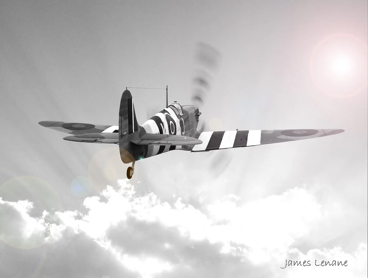 A black and white photo of a World War II-era fighter plane, likely a Supermarine Spitfire, flying through clouds with the…