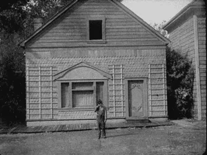 A six-panel black-and-white sequence shows a man standing in front of a house. In the first three panels, the house appears…